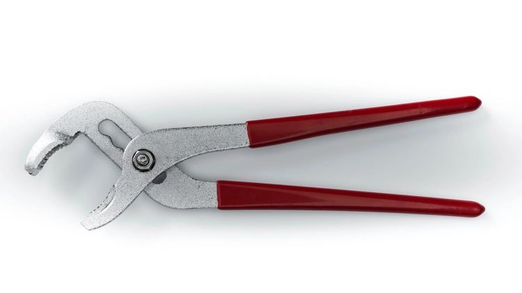 Water-pump pliers with red handles on a white counter
